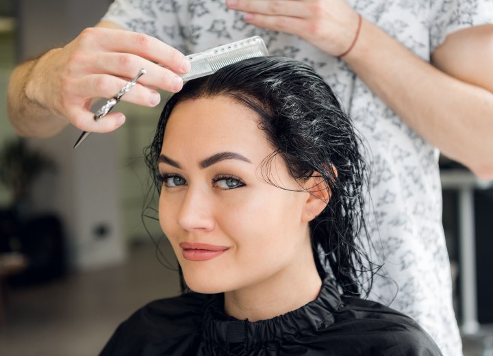Hairdresser adding layers to hair