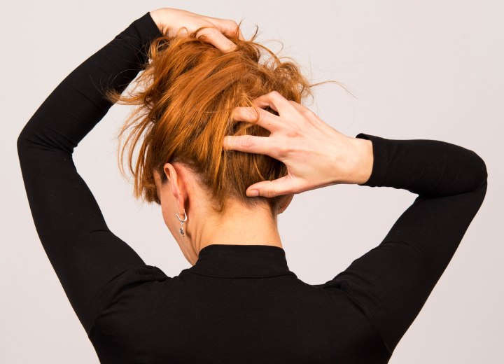 Woman who is checking her hair for bald spots