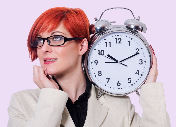Woman with red hair and a clock