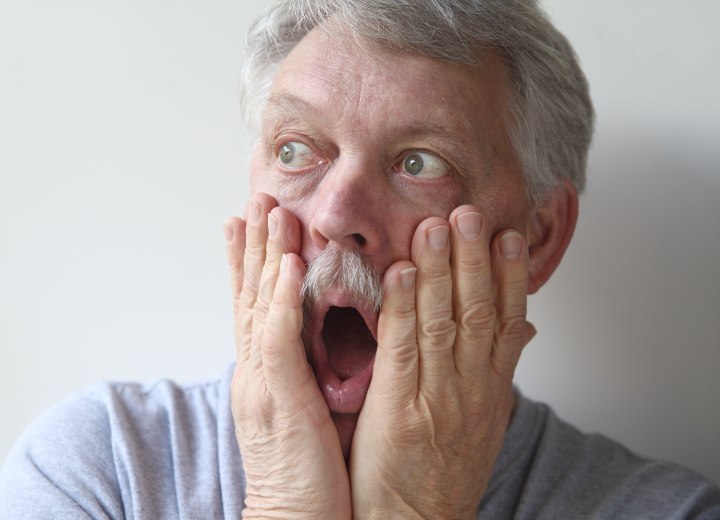 Frightened man with gray hair