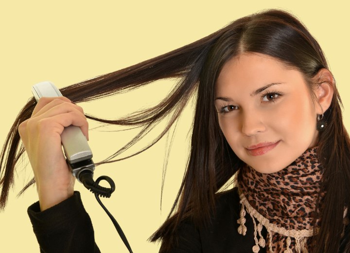 girl straightening her long hair
