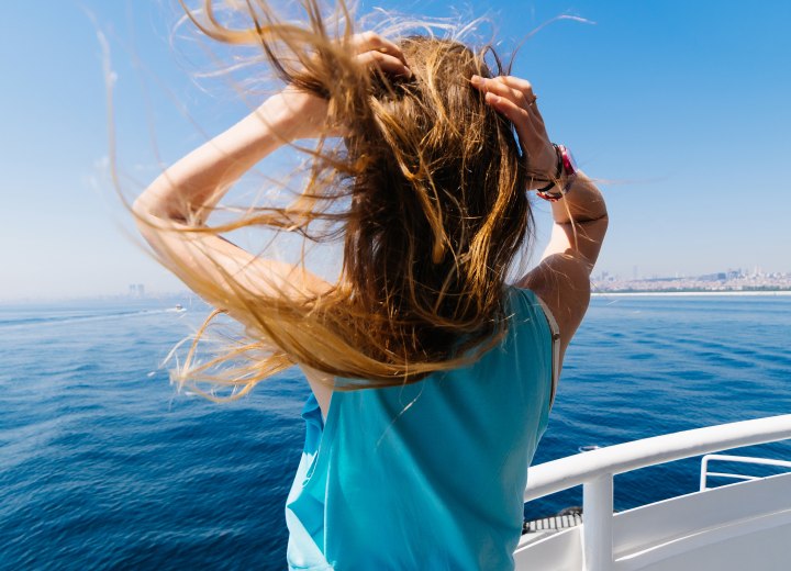 Woman with long hair on a boat