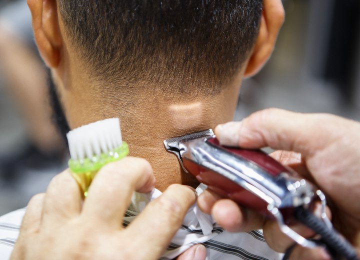 Clipper cutting hair at the nape of the neck