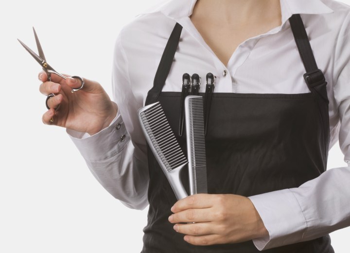 Hair stylist holding combs and scissors