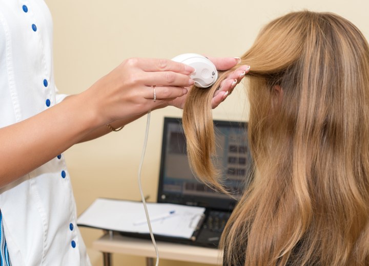 Doctor who is inspecting hair