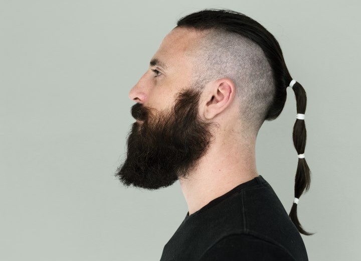 Rat tail hairstyle, a cropped or shaved head with a small 