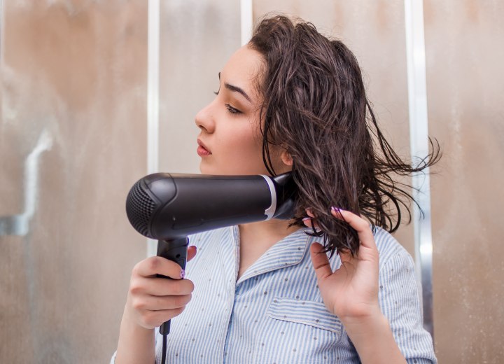 Girl who is blow drying her hair