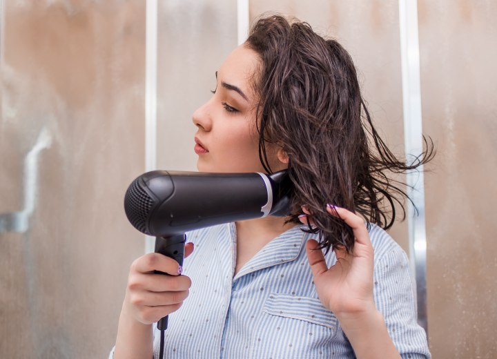 Girl who is blow drying her hair