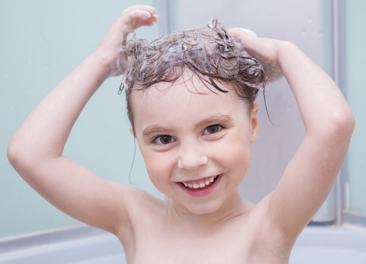 Boy shampooing his own hair with gentle shampoo