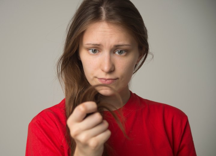 Girl checking her hair for split ends