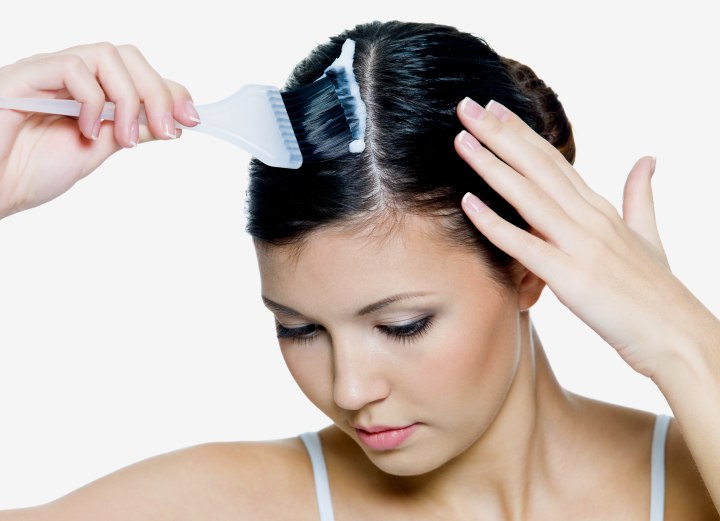 Woman coloring the roots of her hair