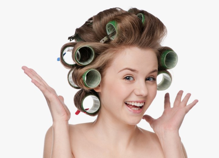 Woman curling her hair with rollers