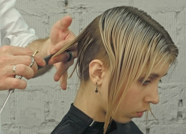 Hair stylist cutting a bob into a pixie style