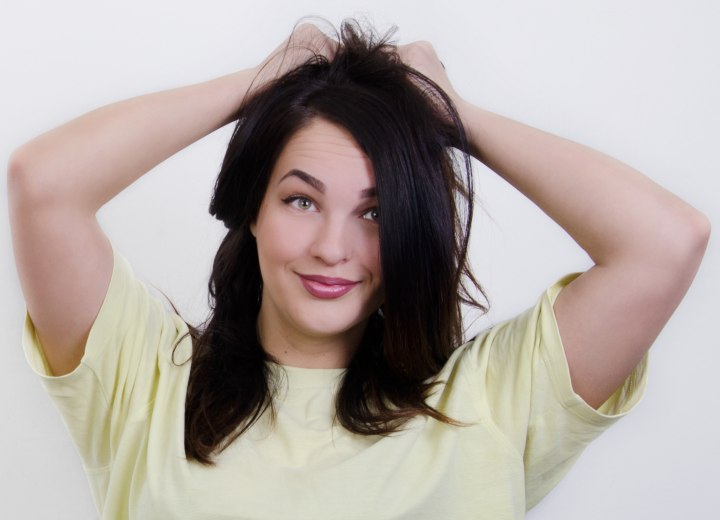 Young woman discovering her first gray hair