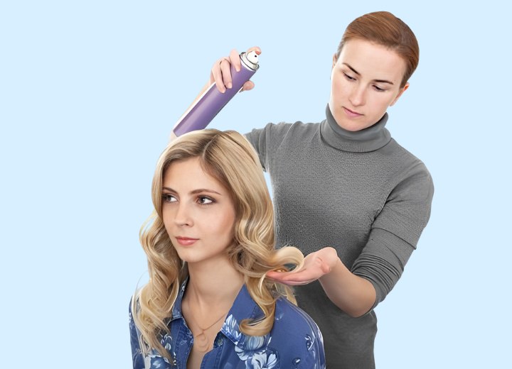 Hairdresser applying hairspray