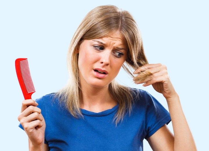 Girl inspecting her hair for breakage