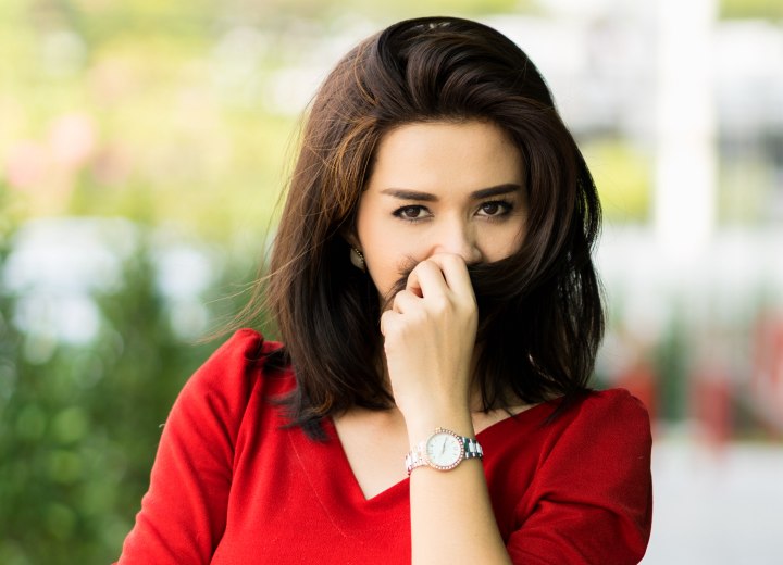 Woman who is smelling her own hair