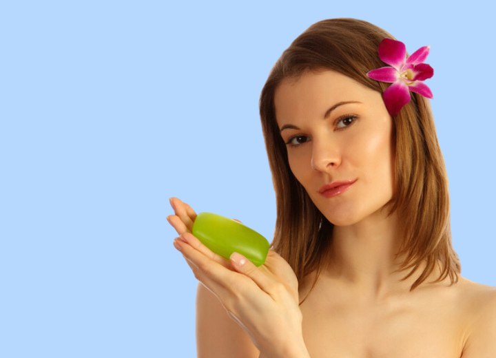 Girl holding a soap bar in her hands