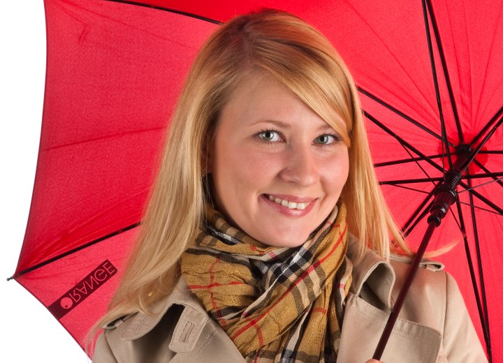 Woman protecting her straightened hair with an umbrella