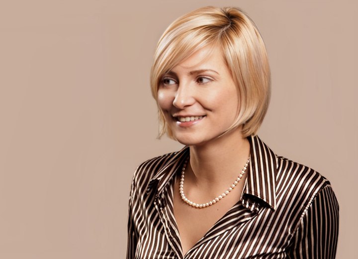 Woman wearing chin length hair and a shiny blouse