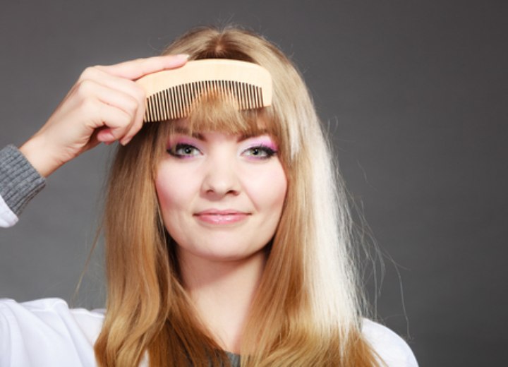 Woman combing her bangs