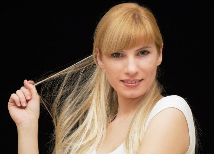 Young woman who is fiddling with her long hair