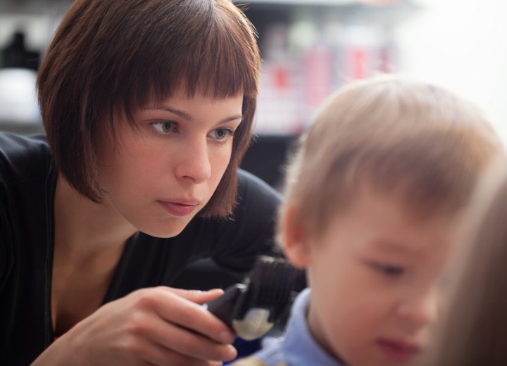 Hairdresser cutting a child's hair