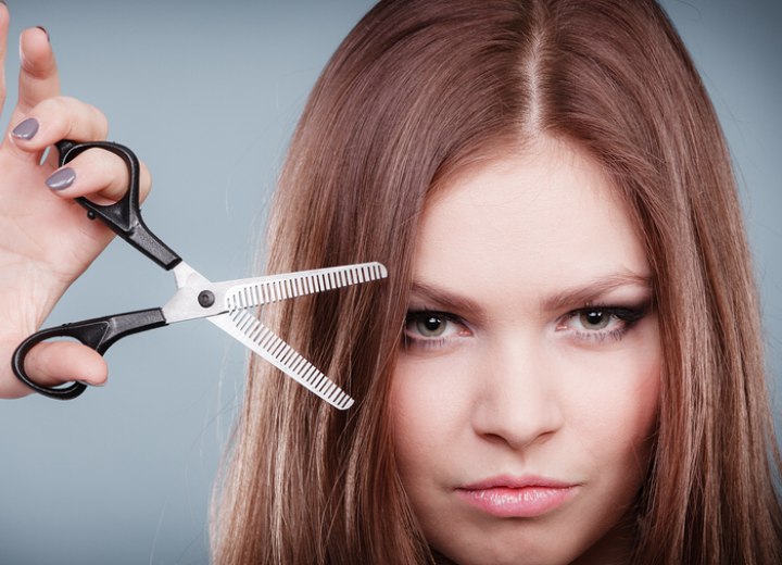 Hairdresser holding thinning scissors