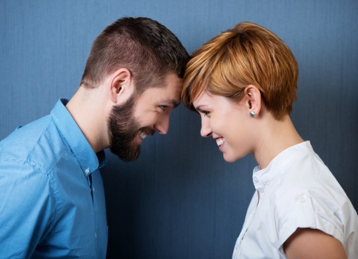 Side profile of a man with a beard and a woman with a pixie cut