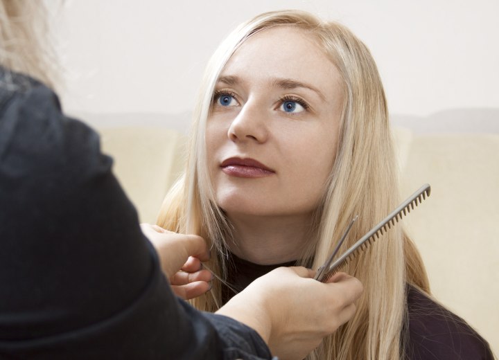 Hairdresser giving her client a personalized haircut