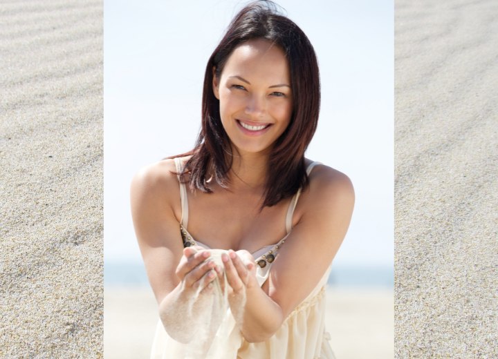 Woman with sand sliding through her fingers
