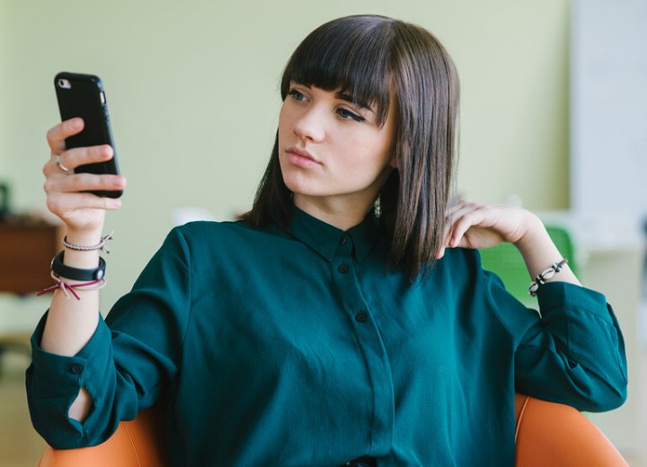 Woman who is reading a bad hair salon review