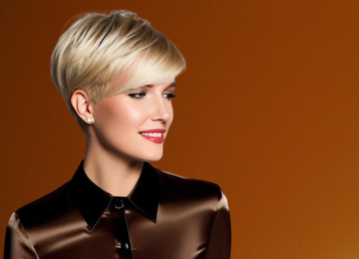 Blonde woman with a spixie cut, wearing a brown shiny silk blouse