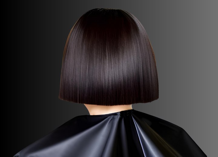 Caped hair salon customer, getting a bob cut