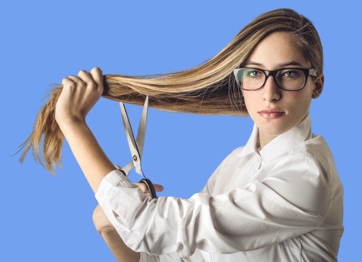 Woman who is about to chop her own long hair off