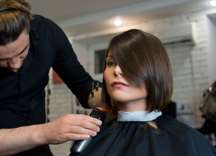Hairdresser cutting a bob with clippers