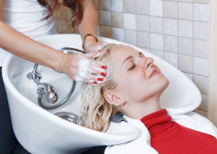 Hairdresser washing hair