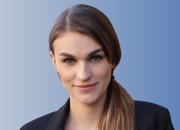 Woman who is wearing her hair in a low side ponytail