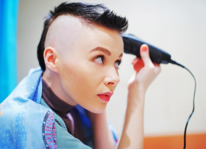 Woman shaving her own head