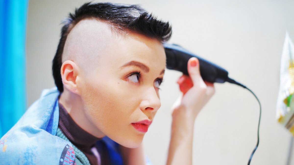 cutting a woman's hair with clippers