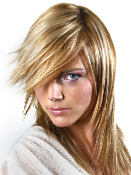 Long hairstyle with razored ends and tri-tones blonde hair coloring