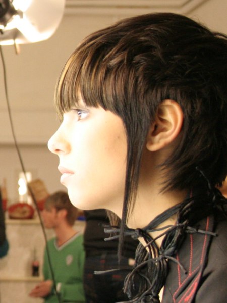 Side view of a unisex haircut with long bangs