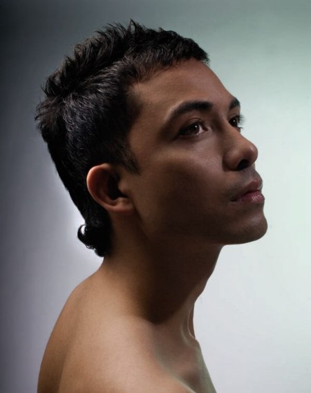 Cropped men's haircut with a longer neck area