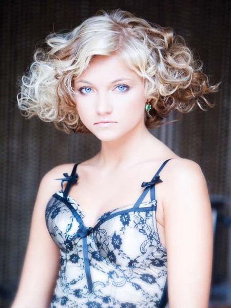 Short hairstyle with a full volume wedge silhouette and curls
