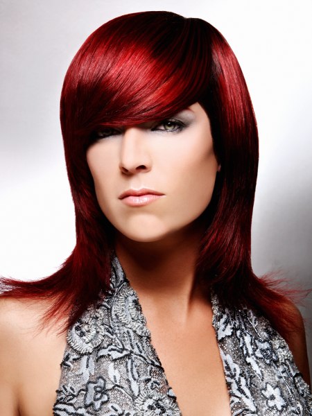 Long red hair with outward turned tips and a heavy rounded fringe