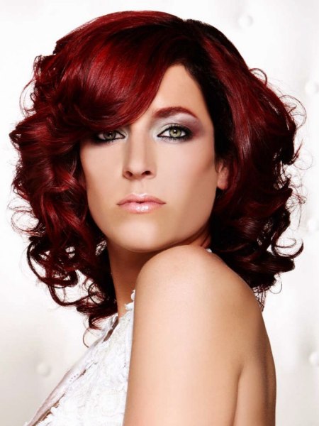 Red hair with curls reaching down to the shoulders