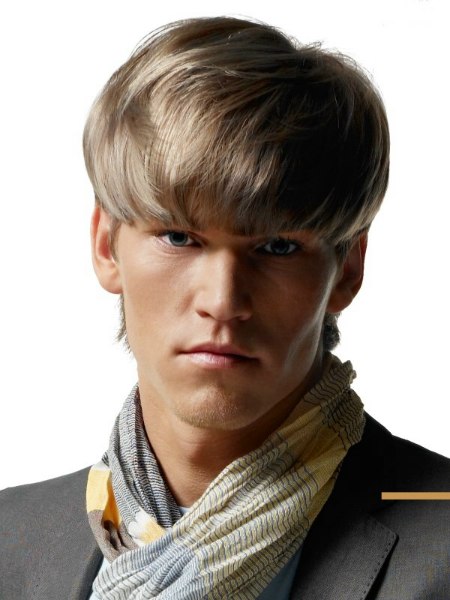 Hairstyle for men with heavy bangs and colors from light to medium blonde