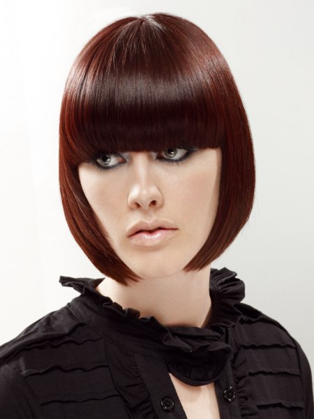 Chin length pageboy cut styled close to the face