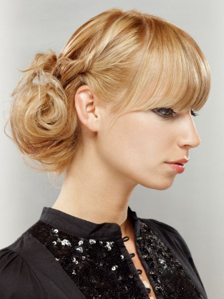 Casual up style with bangs and a loose chignon in the back