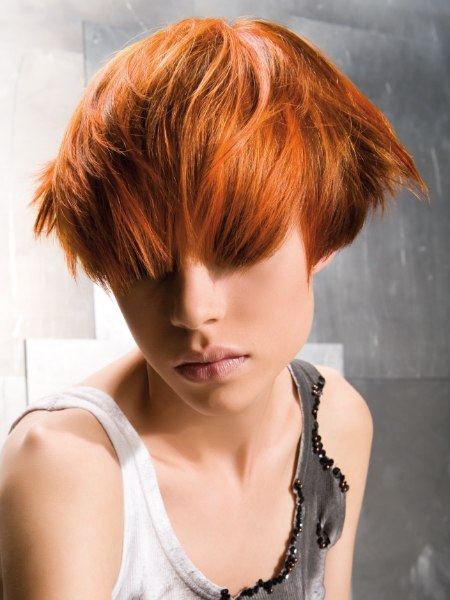 Neo punky haircut with wild strands and the hair directed forward